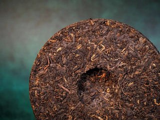 Spring Ming Ripe Pu-erh Tea Cake (2008 Commemoration) – Menghai, Yunnan close-up of back side, revealing detailed leaf texture and tightly rolled tea strands.