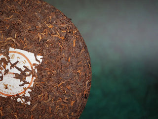 Spring Ming Ripe Pu-erh Tea Cake (2008 Commemoration) – Menghai, Yunnan front close-up emphasizing leaf texture, subtle golden tips, and natural luster.