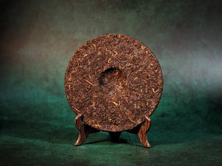 Spring Ming Ripe Pu-erh Tea Cake (2008 Commemoration) – Menghai, Yunnan back view after removing packaging, showing smooth, uniform compressed tea surface.