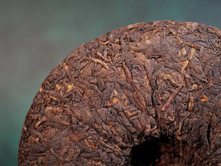 Close-up of the back side of Spring Ming 400g Menghai Ripe Pu-erh Tea Cake – 2020 highlighting glossy, well-fermented leaves.