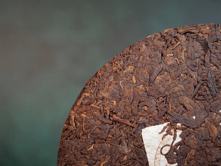 Close-up of the front side of Spring Ming Large 400g Menghai Ripe Pu-erh Tea Cake – 2020 showing golden tips and dense texture.