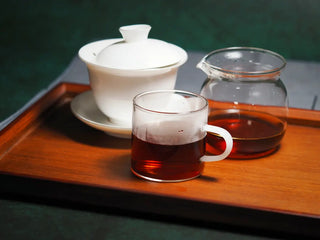 A classic tea setup with gaiwan, glass fairness cup, and tasting cups featuring Spring Ming Large 400g Menghai Ripe Pu-erh Tea.